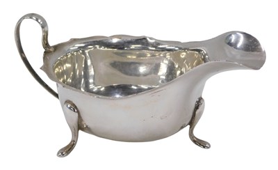 Lot 58 - A George VI silver sauce boat, of stylised...