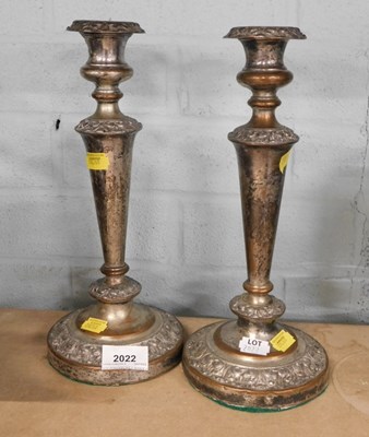 Lot 2022 - A pair of silver plated candlesticks.