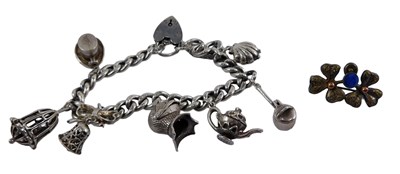 Lot 354 - A silver curb link charm bracelet, with...