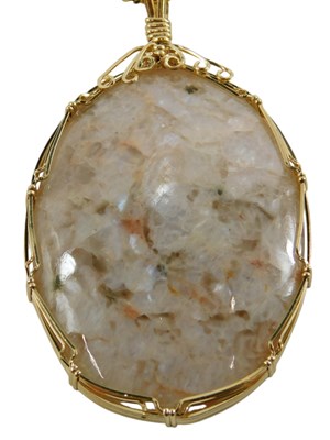 Lot 316 - A quartz pendant and chain, the oval quartz in...