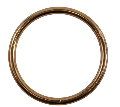 Lot 346 - A hammered hollow bangle, yellow metal stamped...
