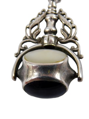 Lot 369 - A swivel agate pendant, set with three faces,...