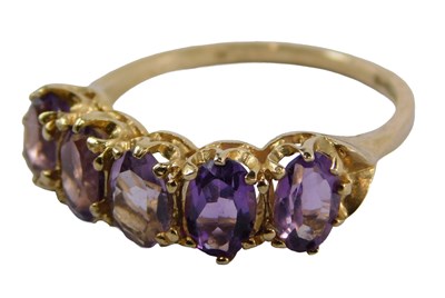 Lot 399 - A 9ct gold amethyst half hoop dress ring, set...