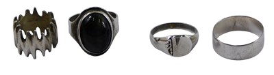 Lot 401 - Four dress rings, comprising abstract dress...