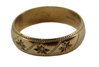 Lot 406 - A 9ct gold wedding band, set with three tiny...