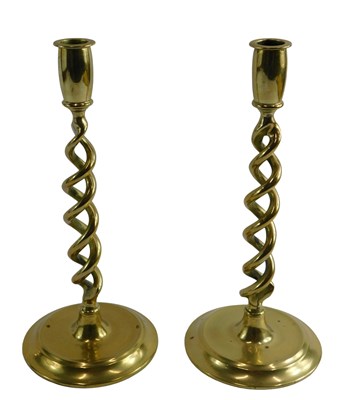 Lot 573 - A pair of brass candlestick holders, each with...