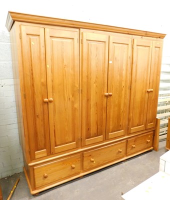 Lot 1504 - A pine freestanding triple wardrobe, 209cm...