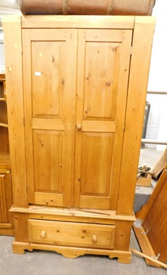 Lot 1521 - A pine two door wardrobe, with single lower...
