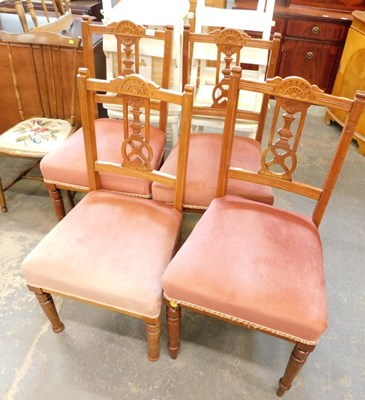 Lot 1540 - Four matching pink upholstered wheel back...