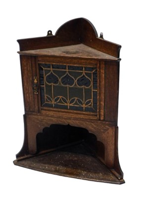 Lot 802 - An Arts & Crafts oak corner cupboard, with...