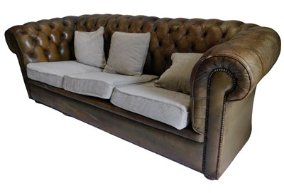 Lot 931 - A green leather Chesterfield settee, with...