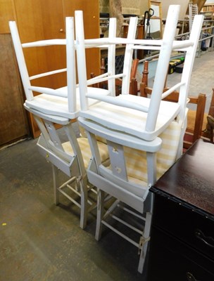 Lot 1540a - Four white painted chapel chairs, with book...