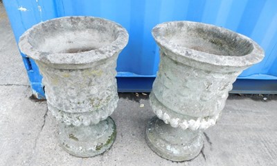 Lot 1604 - A pair of reconstituted stone planters, on...