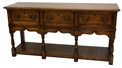 Lot 863 - An oak dresser base, fitted with three frieze...