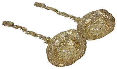 Lot 353 - A pair of late 19thC silver tea strainers,...