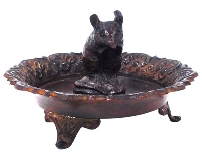 Lot 371 - A 20thC patinated brass nut dish, centred by a...