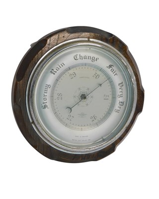 Lot 610 - An early to mid 20thC aneroid barometer, in...