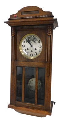 Lot 614 - A 1920s oak wall clock, with German movement,...