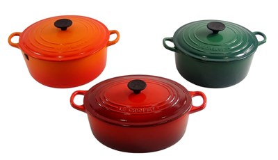 Lot 631 - Three Le Creuset cast iron casserole pots with...