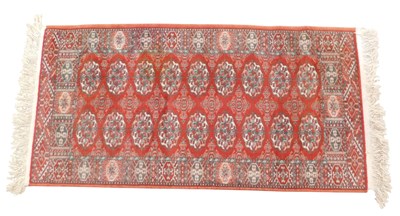 Lot 941 - An Afghan style rug, with a geometric design...