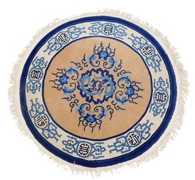 Lot 771 - A Chinese cut wool circular rug, with a design...