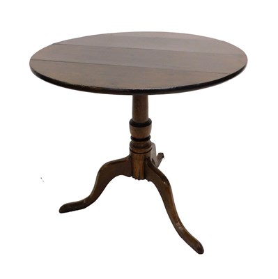 Lot 725 - A 19thC oak tilt top table, on a turned column...