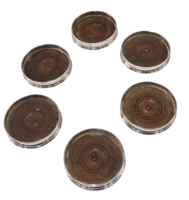 Lot 457 - A set of six circular silver wine coasters, of...