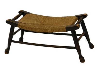 Lot 740 - An oak stool in Liberty style, with rattan...