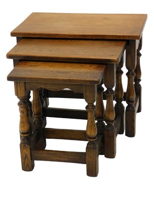 Lot 742 - A nest of three oak tables, with turned...