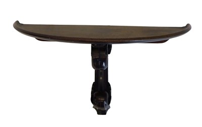Lot 745 - A demi-lune shaped wall bracket, with dished...