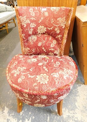 Lot 1528a - A red floral upholstered nursing chair. 
The...