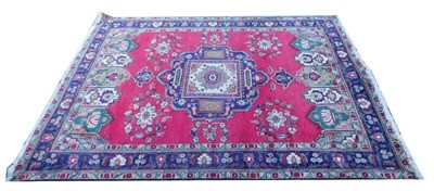 Lot 801a - A Persian Tabriz red ground rug, with central...
