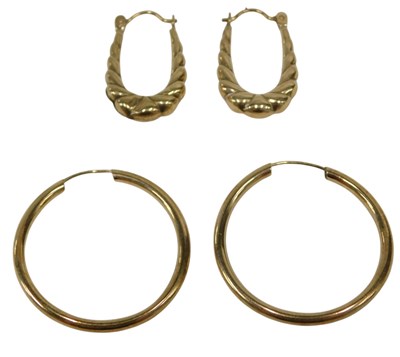 Lot 175 - Two pairs of 9ct gold hoop earrings,...