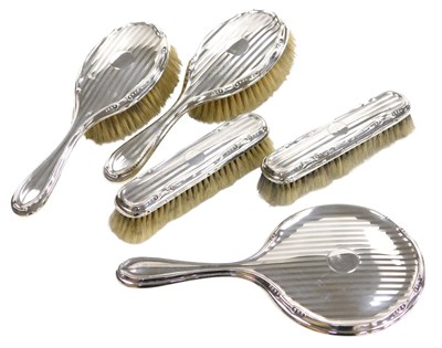 Lot 105 - A George V silver backed five piece dressing...