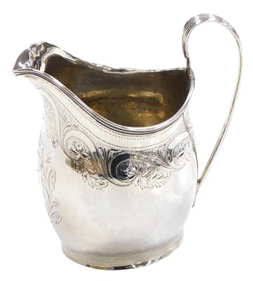 Lot 110 - A George III silver helmet shaped cream jug,...