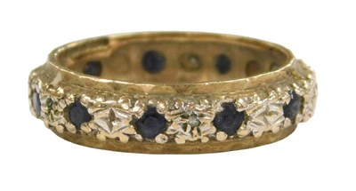 Lot 205 - A 9ct bicolour gold and sapphire full eternity...
