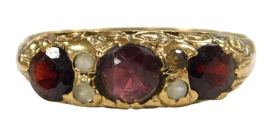 Lot 219 - A 9ct gold and garnet three stone ring,...