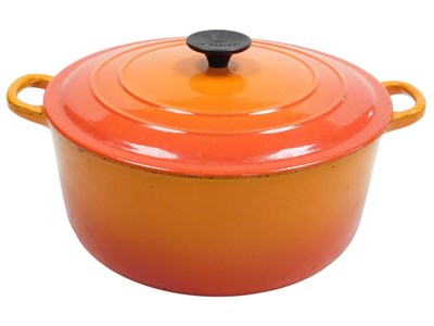Lot 249 - A Le Creuset orange and red twin handled...