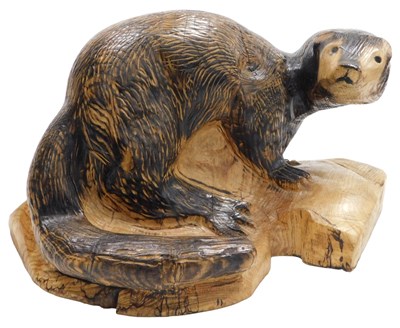Lot 250 - A carved wooden figure of an otter, 42cm wide.