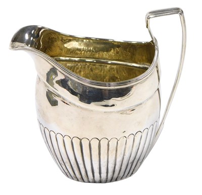 Lot 419 - A George III silver semi fluted cream jug,...