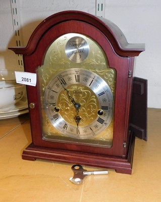Lot 2081 - A Hermle mantel clock, the brass dial bearing...