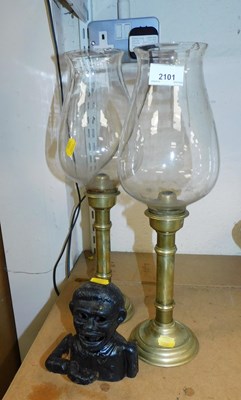 Lot 2101 - A pair of brass candlesticks, each with a...