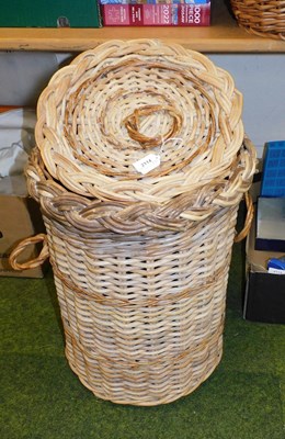 Lot 2114 - A wicker lidded two handled laundry...