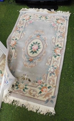 Lot 2117 - A Chinese wool rug, pink ground, decorated...