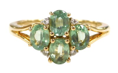 Lot 551 - A 9ct gold emerald and diamond four stone ring,...