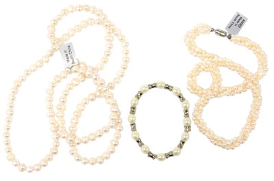 Lot 555 - A long fresh water pearl necklace, together...