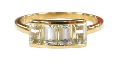 Lot 558 - A 9ct gold and aquaiba four stone ring,...