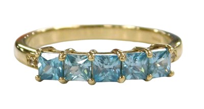 Lot 562 - A 9ct gold and blue zircon four stone...