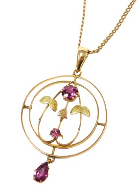 Lot 570 - An Edwardian amethyst floral circular pendant,...