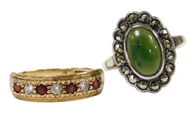 Lot 571 - A 9ct gold garnet and cz seven stone ring,...